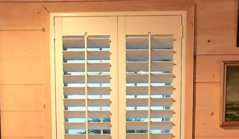  Plantation shutters in a long window.